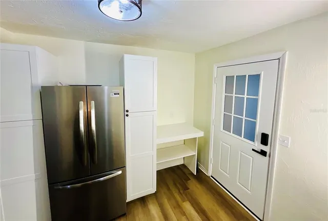 a kitchen with a refrigerator and a stove top oven