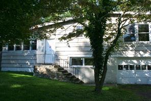 a view of house with backyard