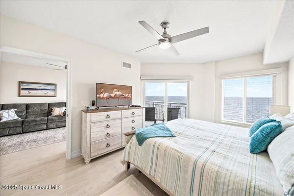a bedroom with a bed a window and a couch