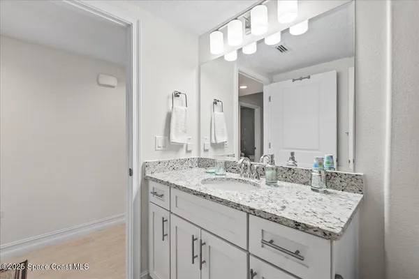 a bathroom with a sink double vanity and a mirror