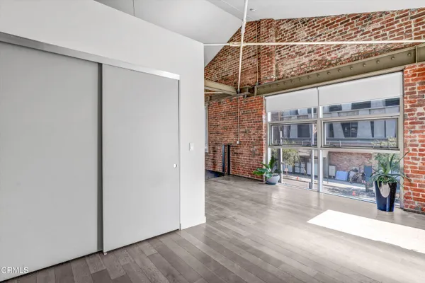 a view of a glass door with wooden floor