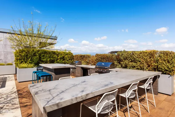 a view of a patio with dining table and chairs