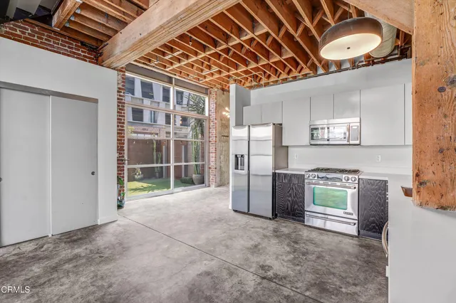 a view of an empty room with a fireplace