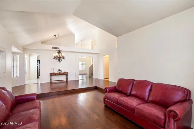 a living room with furniture and a chandelier
