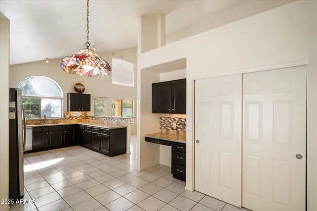 a kitchen with stainless steel appliances granite countertop a refrigerator and a stove top oven