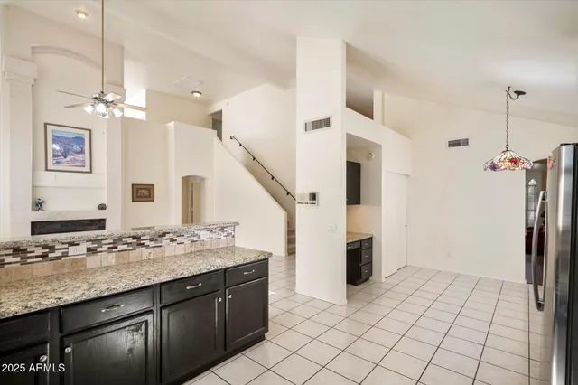 a large bathroom with a large mirror sink and cabinets