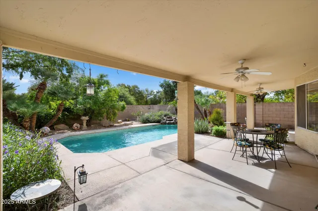 a view of a patio with a dining table and chairs