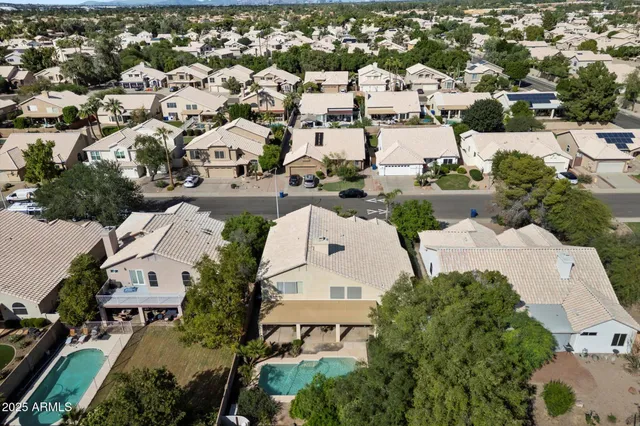 an aerial view of residential houses with outdoor space