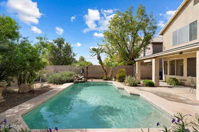 a front view of a house with a yard and potted plants