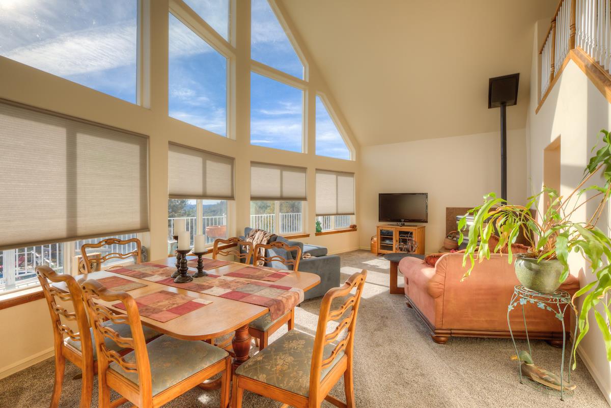 83 Northfork Road Berry Creek, CA 95916 - Photo 12 of 56 a view of a dining room with furniture window and a chandelier