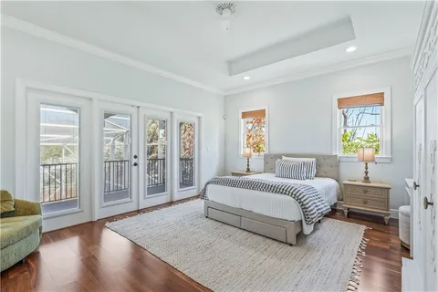 a spacious bedroom with a bed a couch and a window