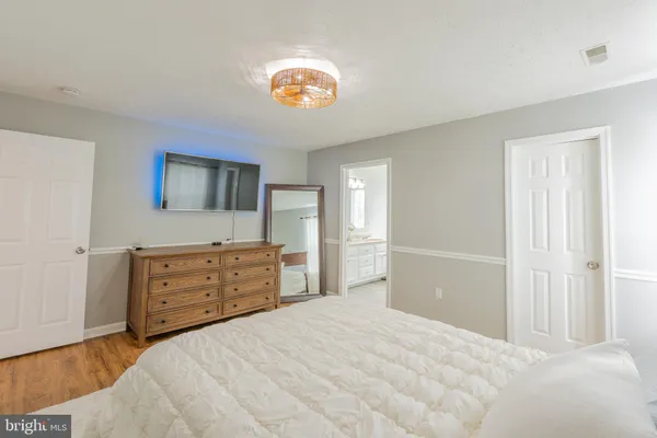 a bedroom with a bed and a dresser