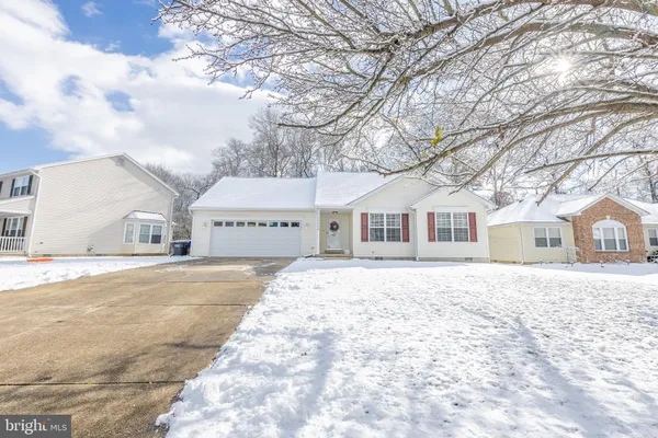 a view of house with yard covered in snow