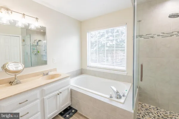 a bathroom with a granite countertop sink a toilet and shower