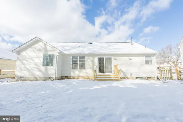 a view of a house with a large windows and a large tree