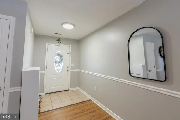 a view of a livingroom with wooden floor and a window