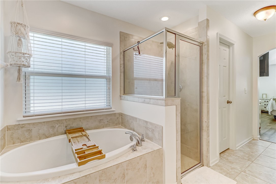 97642 Albatross Drive Yulee, FL 32097 - Photo 16 of 27 a bathroom with a bathtub and a shower