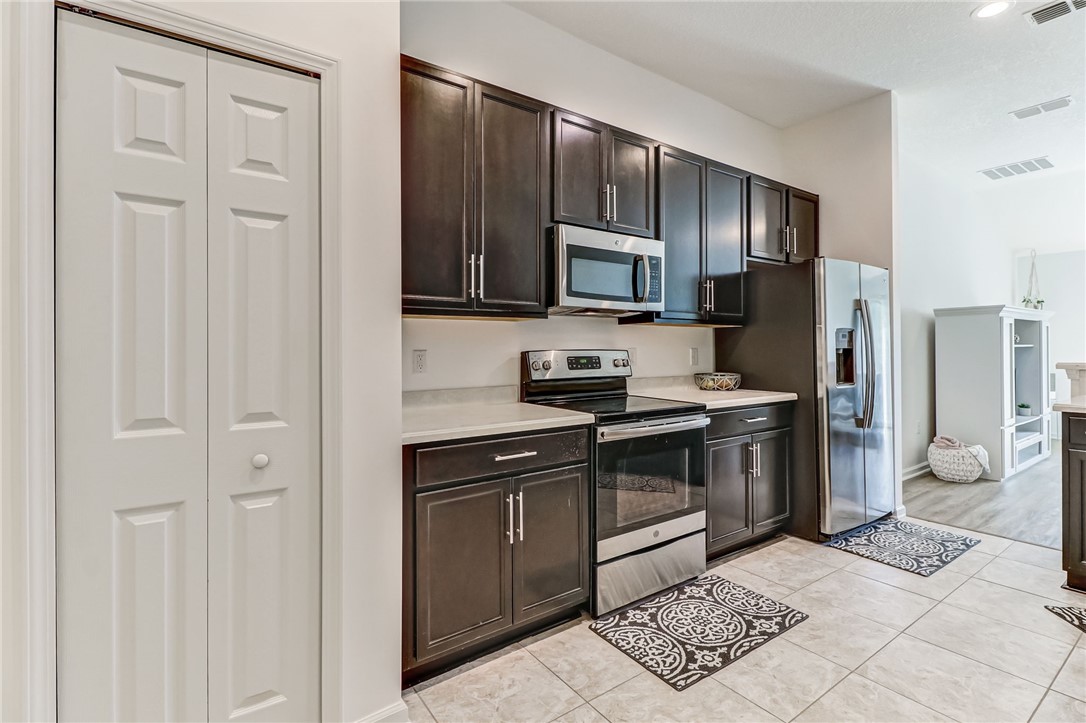 97642 Albatross Drive Yulee, FL 32097 - Photo 2 of 27 a kitchen with stainless steel appliances granite countertop a refrigerator stove and sink
