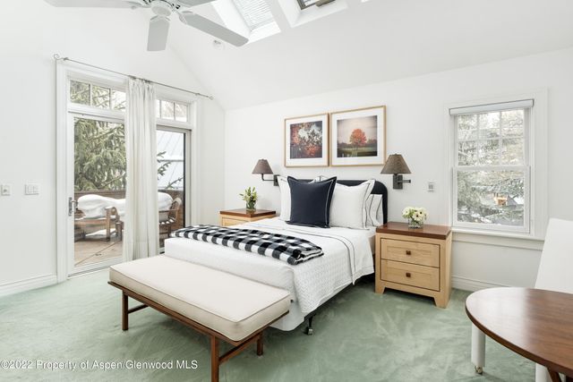 a bedroom with a bed chair and a window