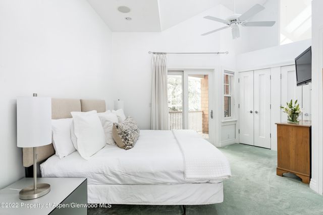 a bedroom with a bed and a potted plant