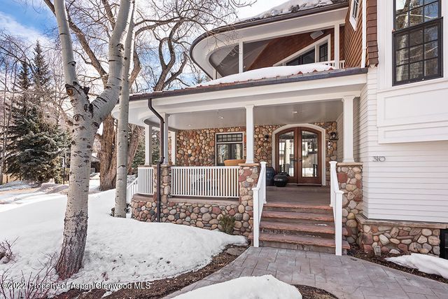 a view of a house with a small yard and wooden fence