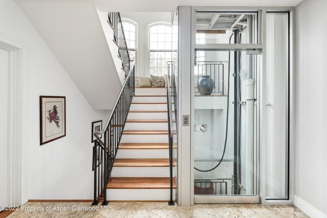a view of staircase with white walls and windows