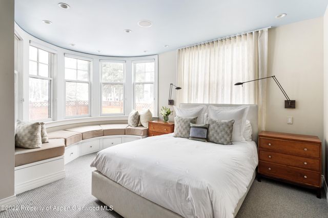 a spacious bedroom with a large bed and a window