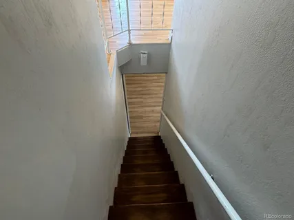 a view of a hallway with stairs