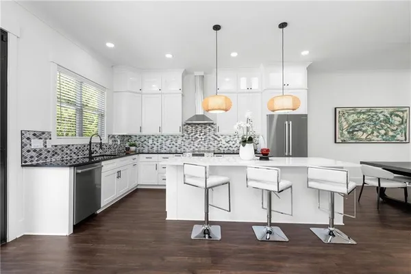 a kitchen with a table chairs and a kitchen view