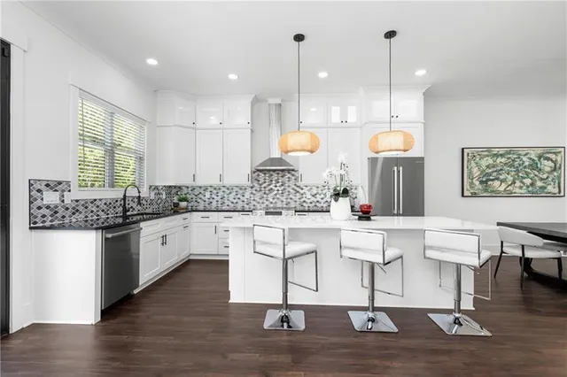 a kitchen with a table chairs and a kitchen view