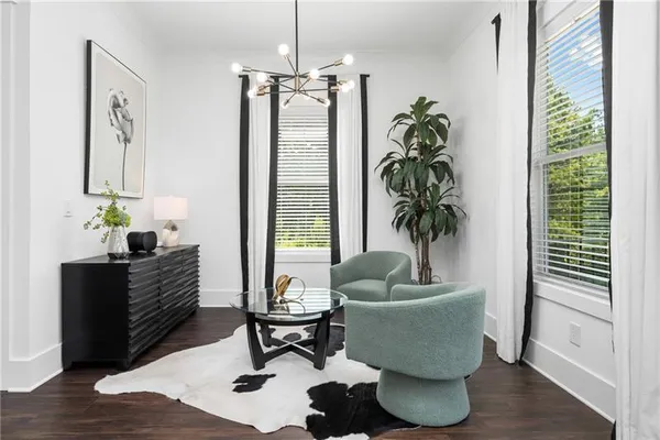 a spacious bedroom with a bed a couch and a flat tv screen