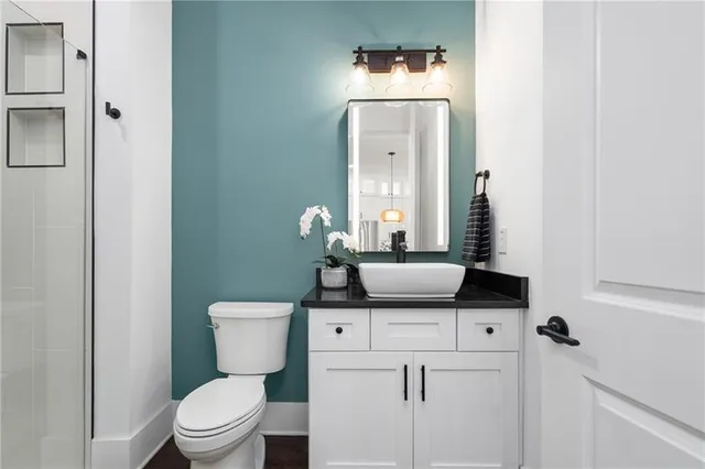 a bathroom with a double vanity sink mirror and bathtub