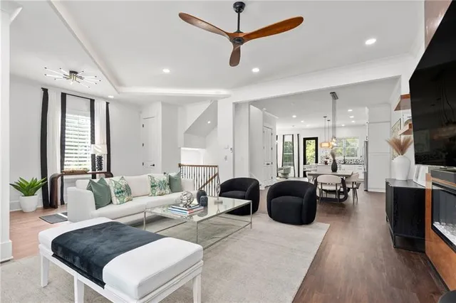 a living room with furniture and wooden floor