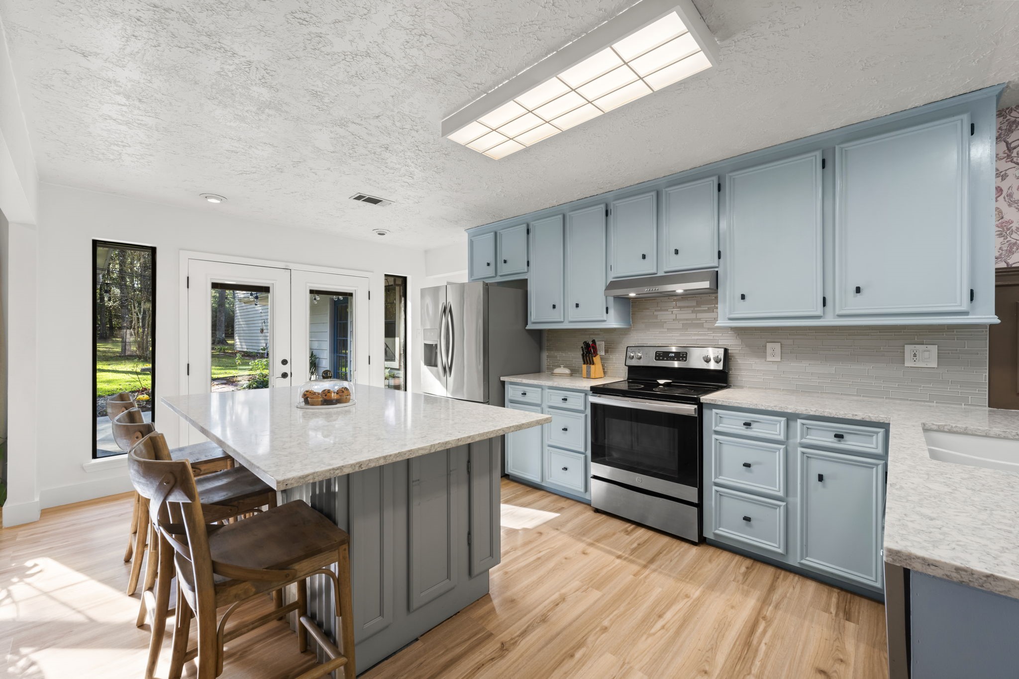 8623 Miller Road Magnolia, TX 77354 - Photo 12 of 44 a kitchen with a stove a sink and a refrigerator
