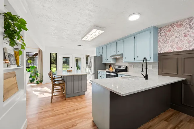 a bedroom with a large bed and a dresser