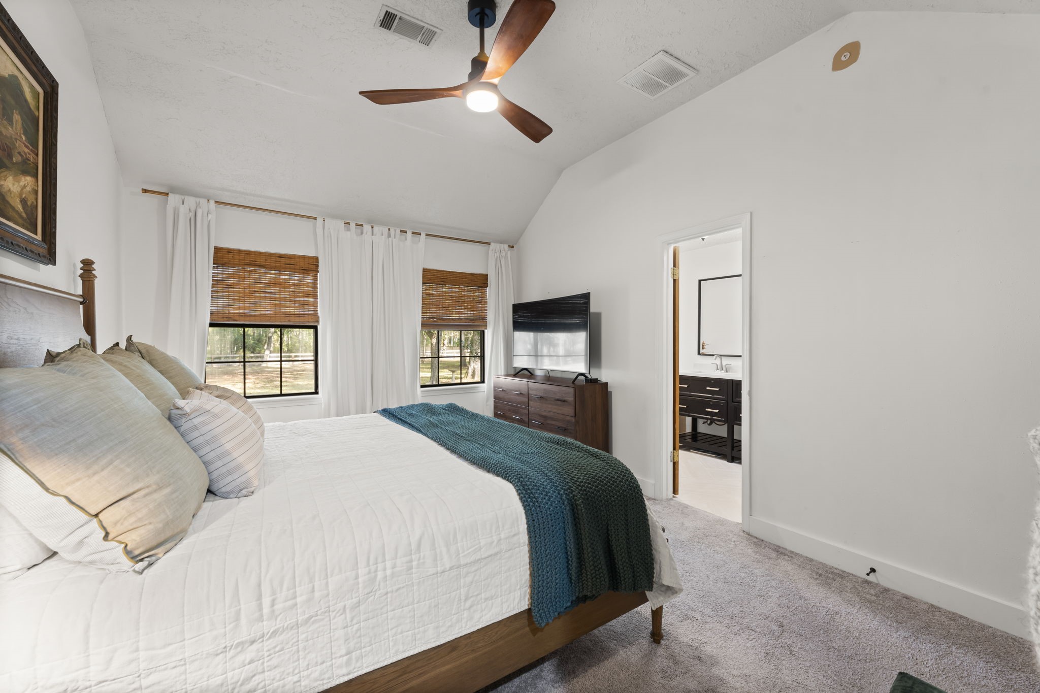 8623 Miller Road Magnolia, TX 77354 - Photo 16 of 44 a bedroom with a large bed and a dresser