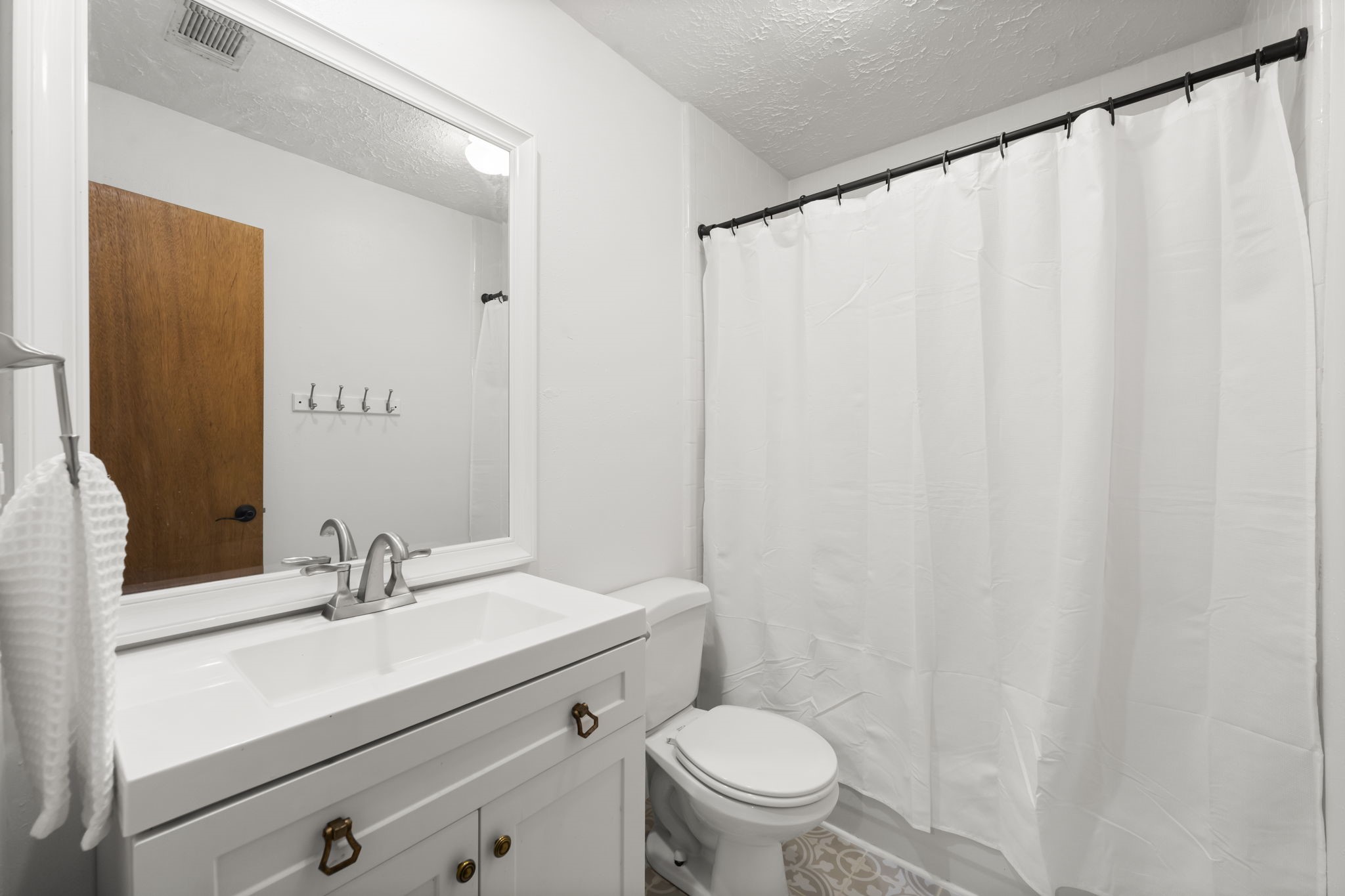 8623 Miller Road Magnolia, TX 77354 - Photo 20 of 44 a bathroom with a sink a toilet and a mirror