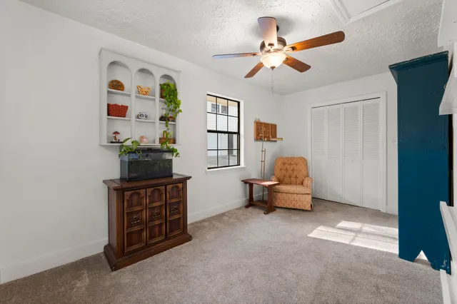 a front view of a house with a patio table and chairs