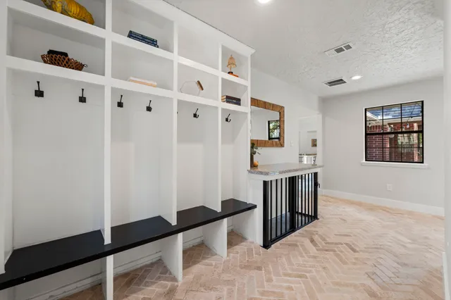 a dining room with furniture and a floor to ceiling window