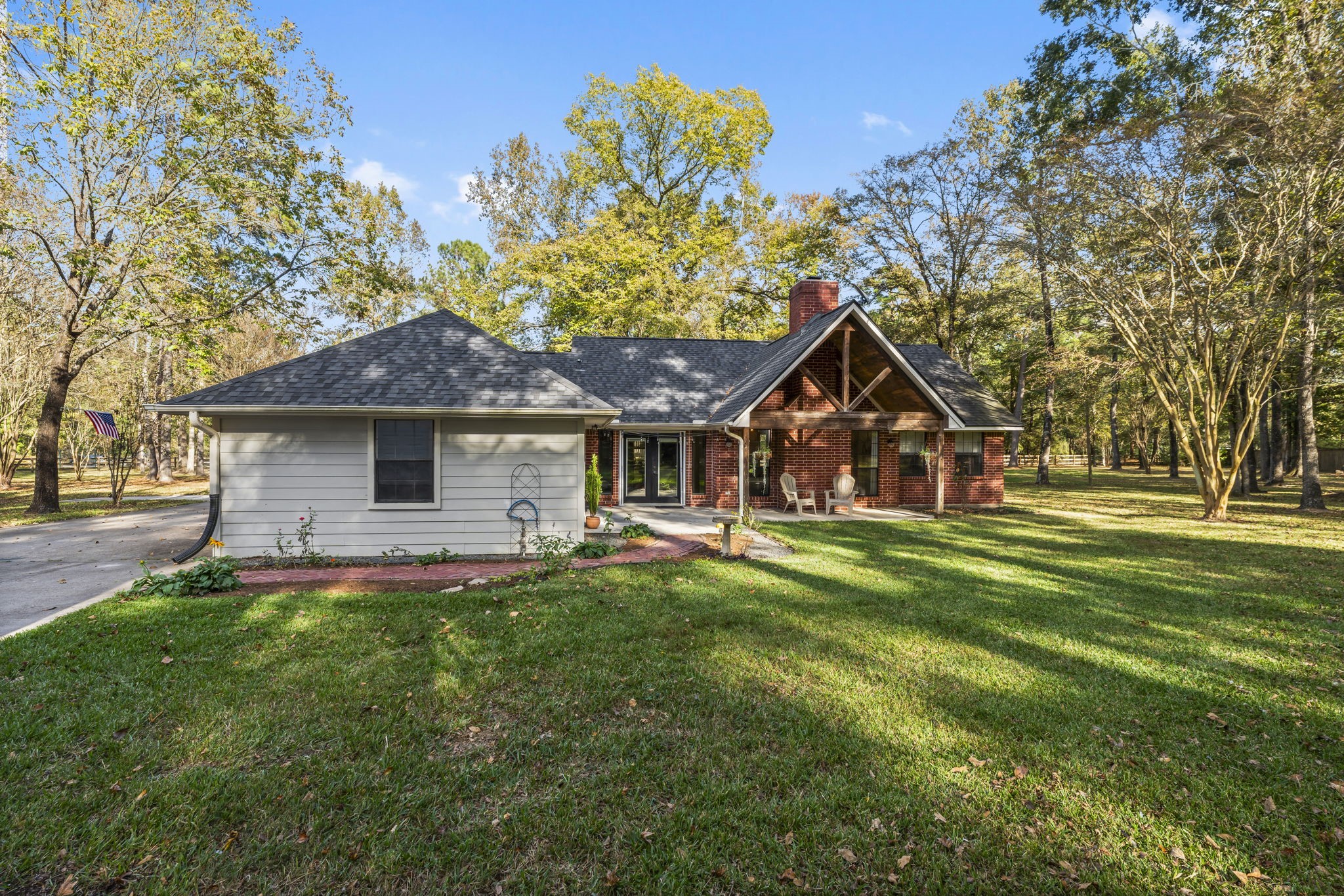 8623 Miller Road Magnolia, TX 77354 - Photo 26 of 44 a front view of a house with a garden and trees