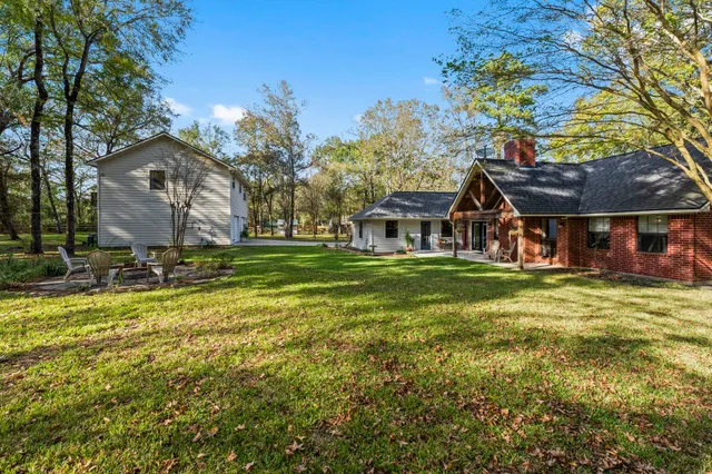 a bathroom with a sink a toilet a mirror and shower