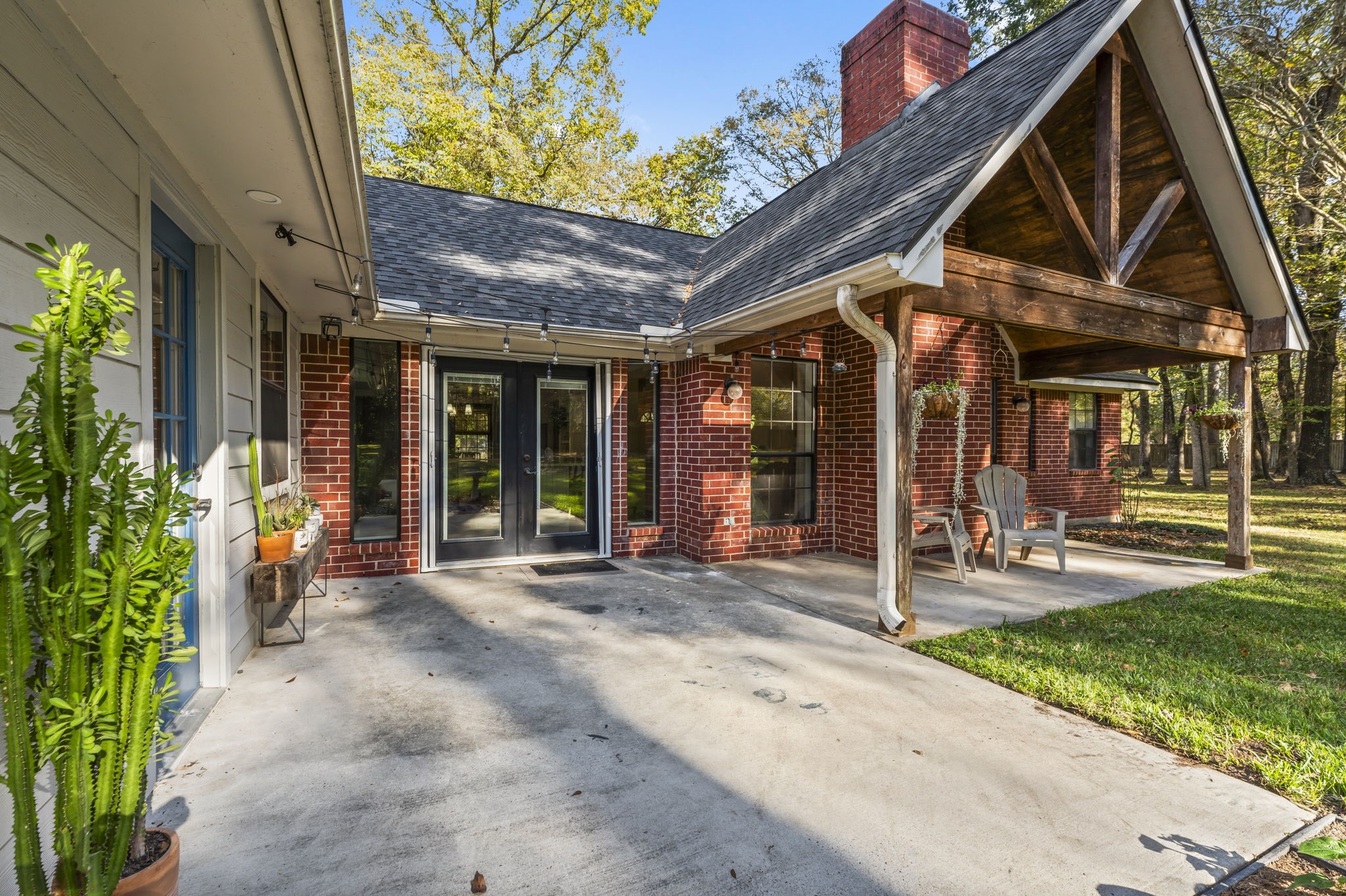 8623 Miller Road Magnolia, TX 77354 - Photo 32 of 44 a front view of a house with a patio table and chairs