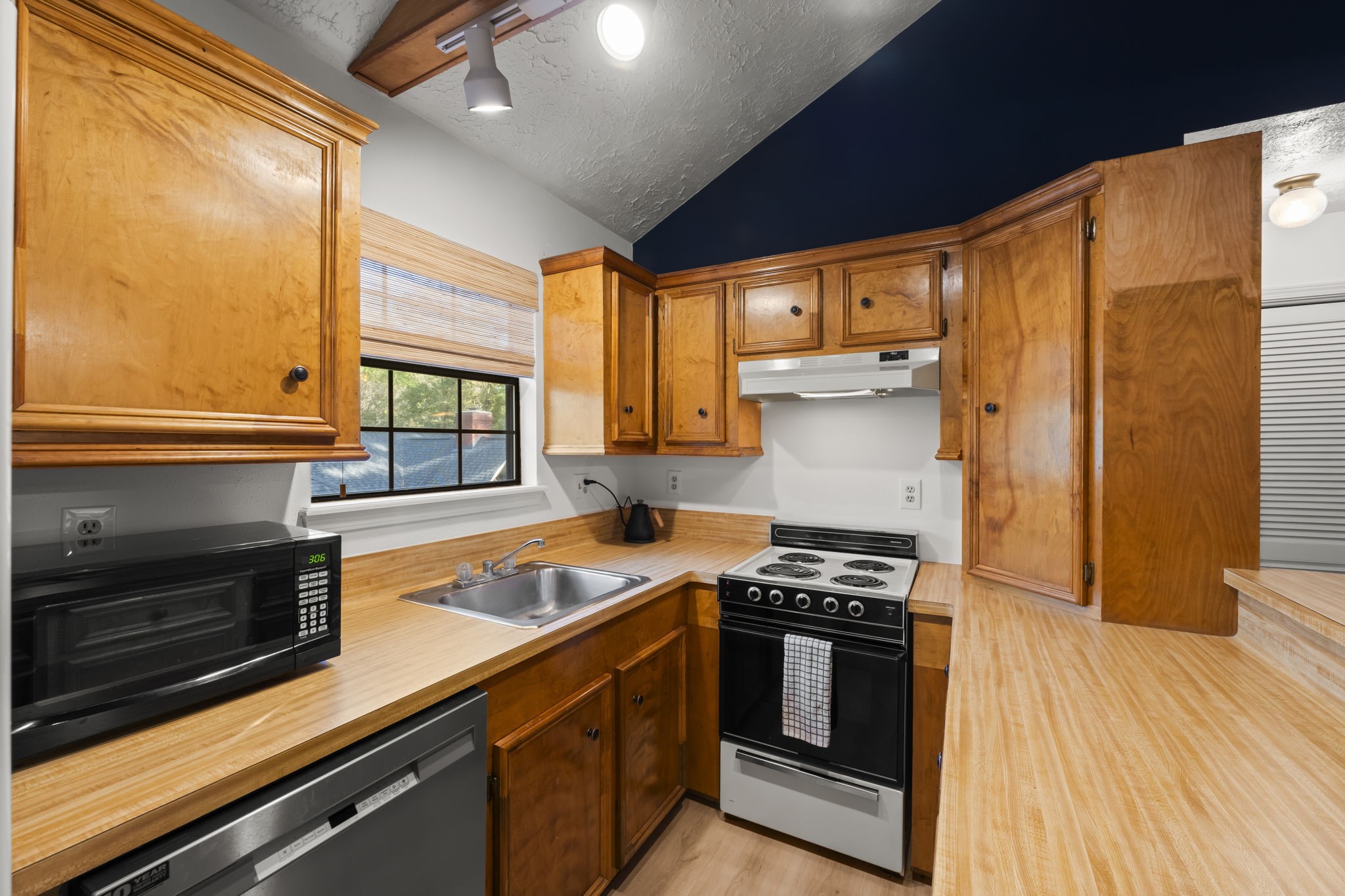 8623 Miller Road Magnolia, TX 77354 - Photo 39 of 44 a kitchen with stainless steel appliances a stove sink and cabinets