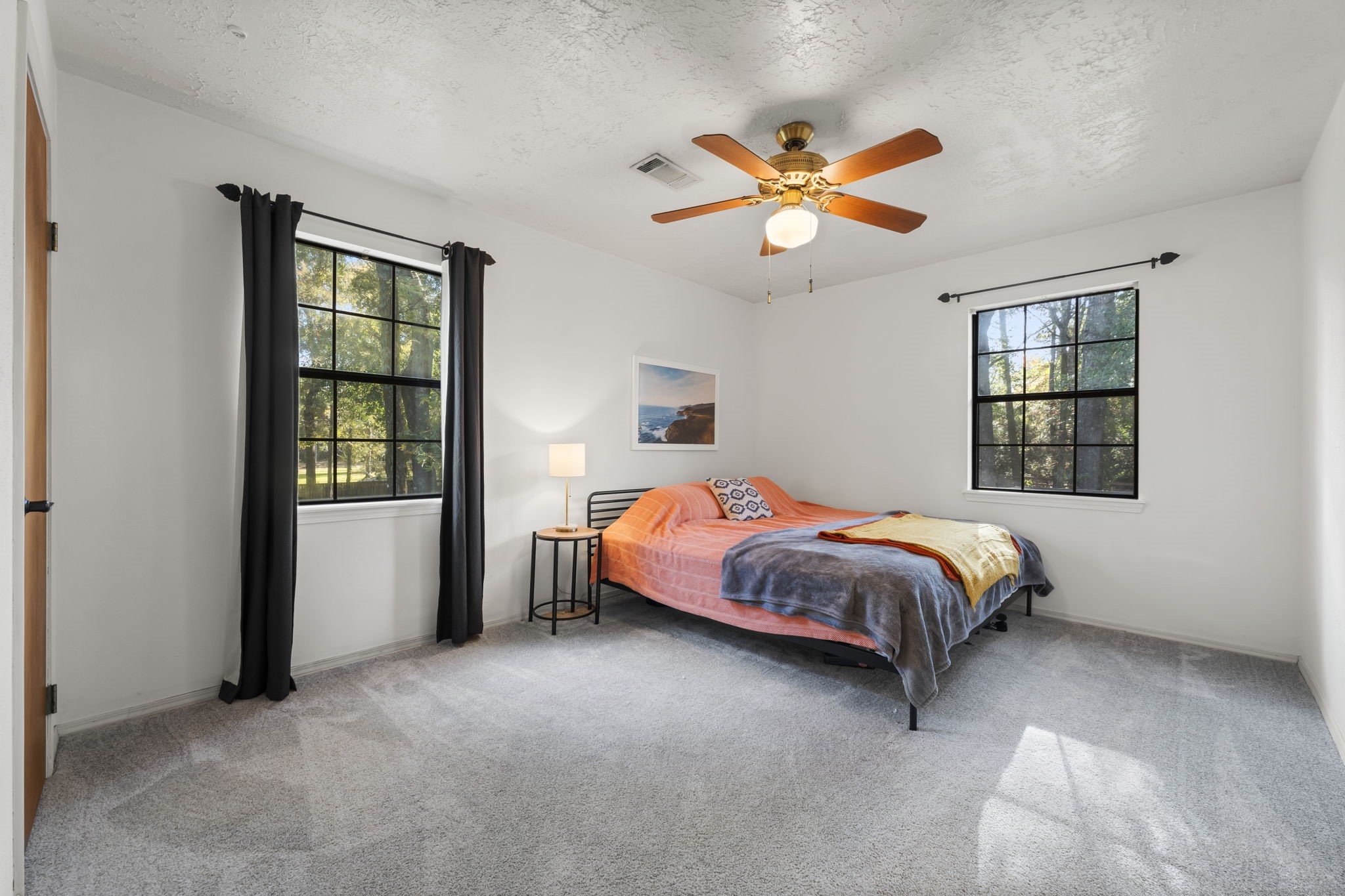 8623 Miller Road Magnolia, TX 77354 - Photo 40 of 44 a bed sitting in a bedroom next to a window