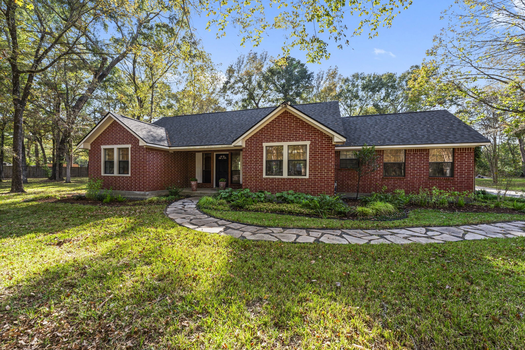 8623 Miller Road Magnolia, TX 77354 - Photo 4 of 44 a front view of a house with a yard and garage