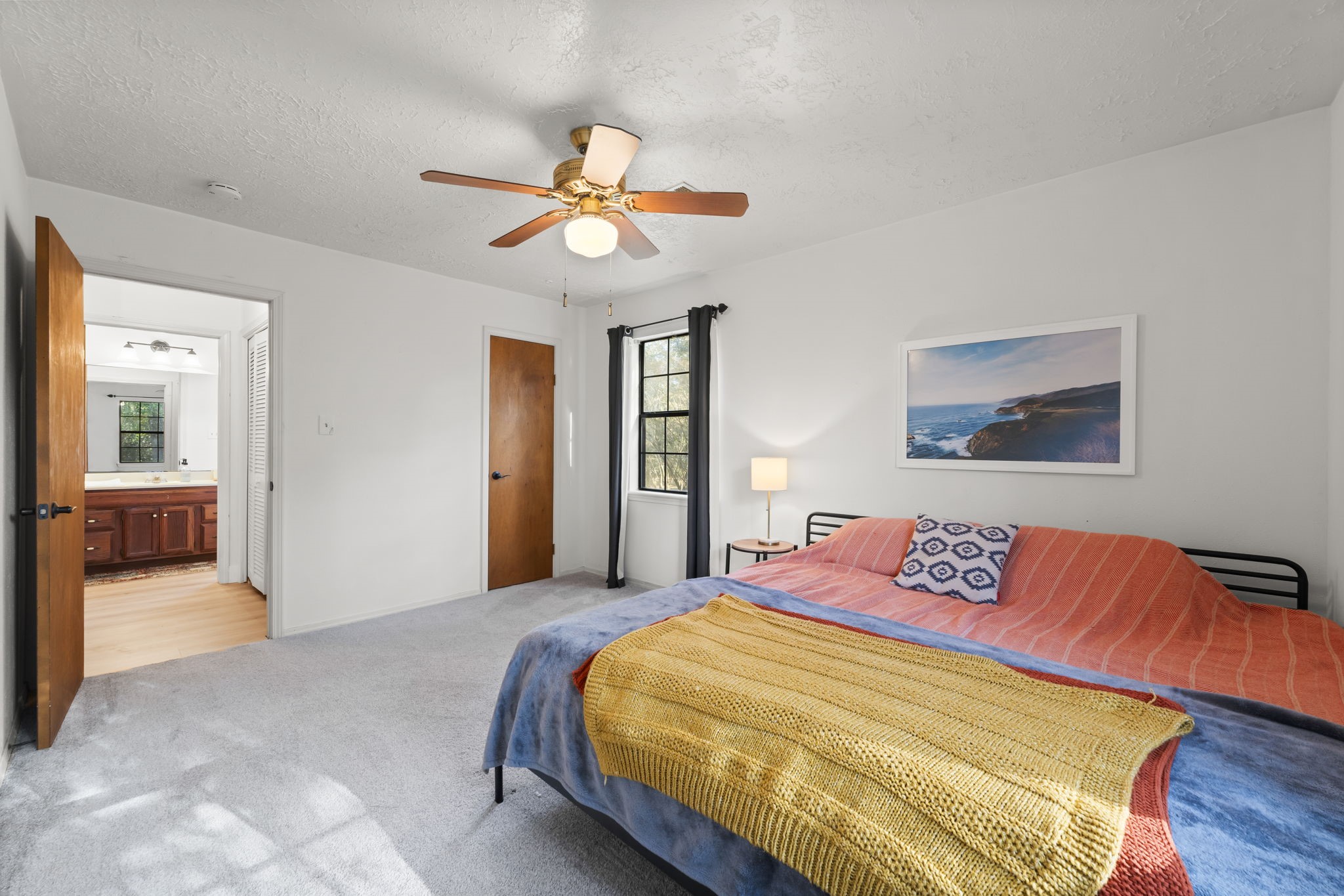 8623 Miller Road Magnolia, TX 77354 - Photo 41 of 44 a bedroom with a large bed and a chandelier