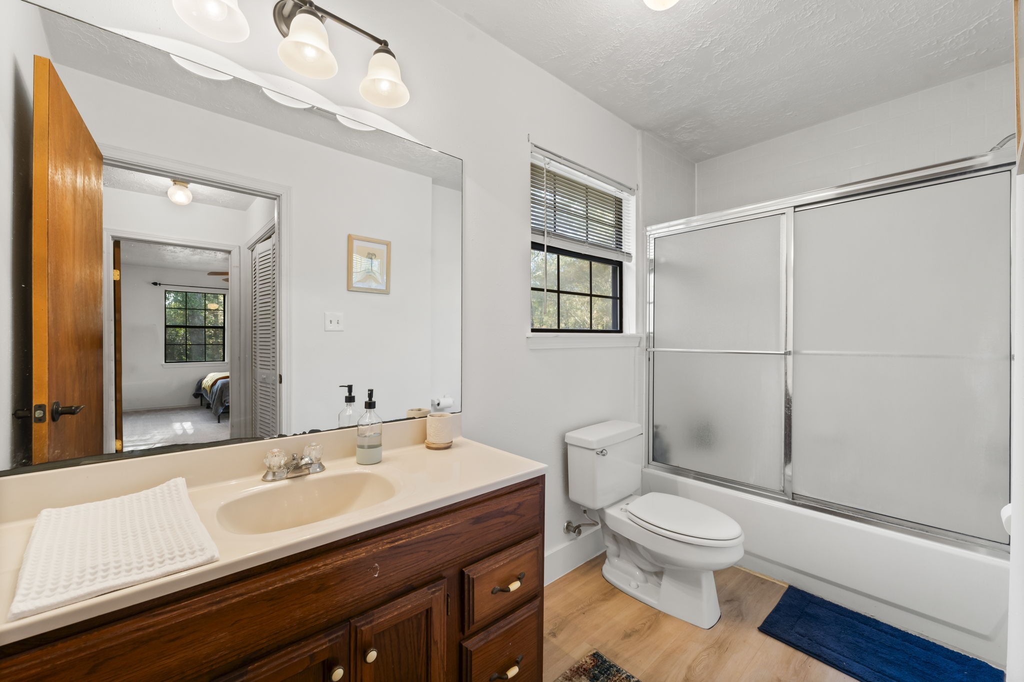 8623 Miller Road Magnolia, TX 77354 - Photo 42 of 44 a bathroom with a sink a toilet a mirror and shower