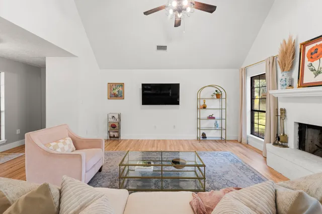 a living room with furniture fireplace and flat screen tv