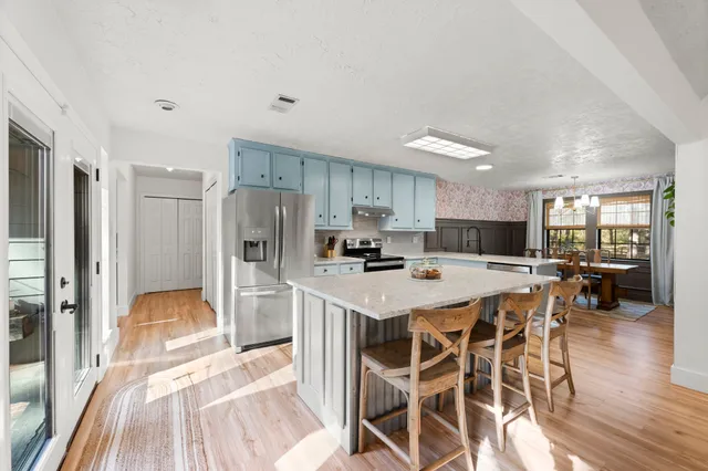 a kitchen with a stove a sink and a refrigerator