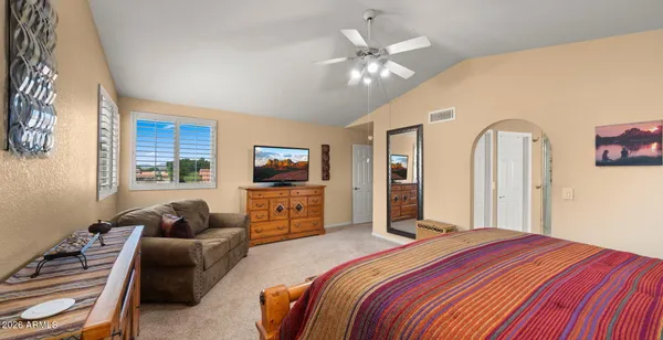 a living room with furniture a chandelier and a large mirror